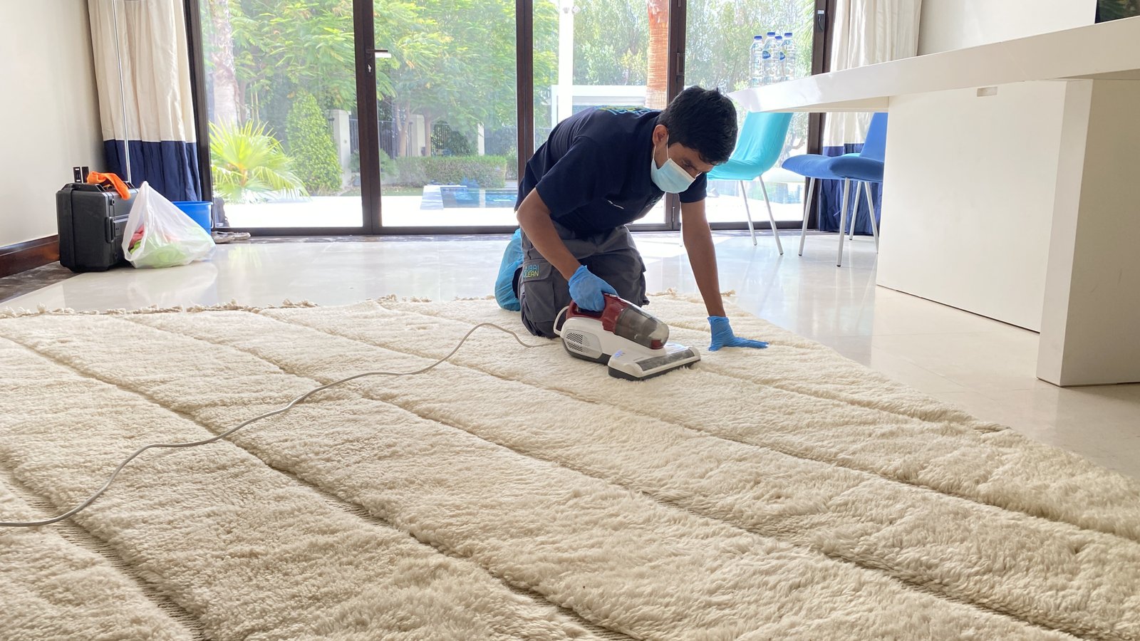 Person cleaning carpet at home using vacuum cleaner and cleaning solution with before and after results showing clean carpet