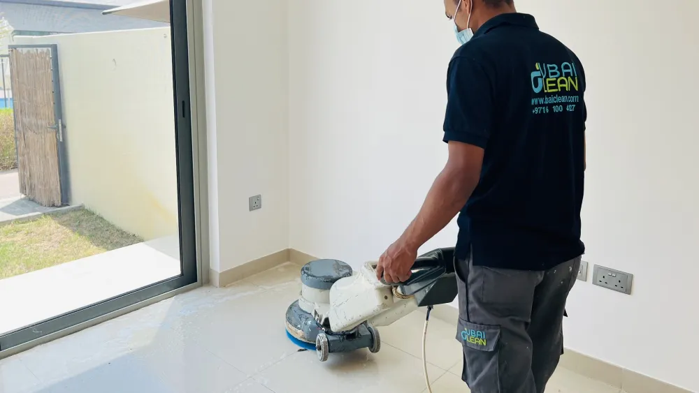 Cleaning professional scrubbing a tiled floor to remove dirt buildup