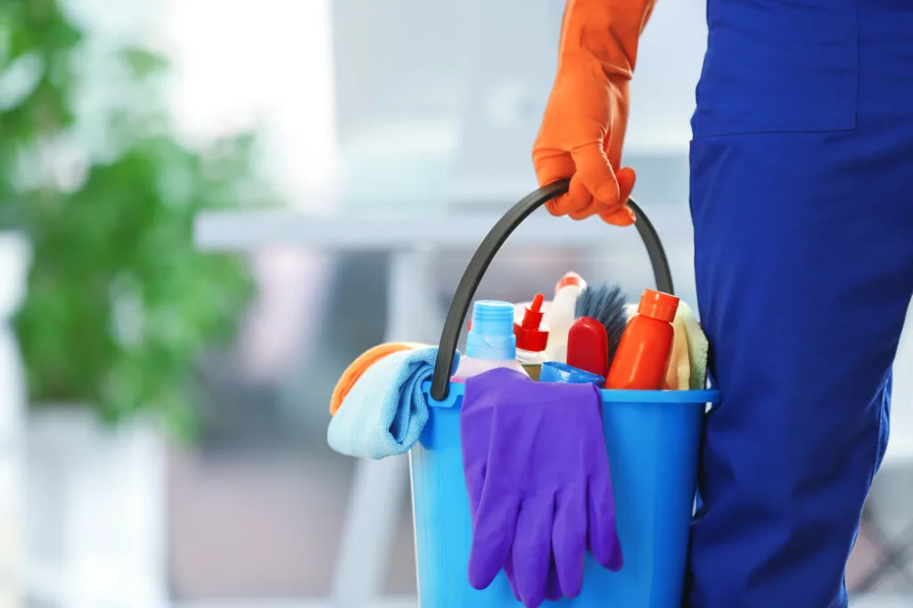 A bucket containing tools and detergents for effective cleaning
