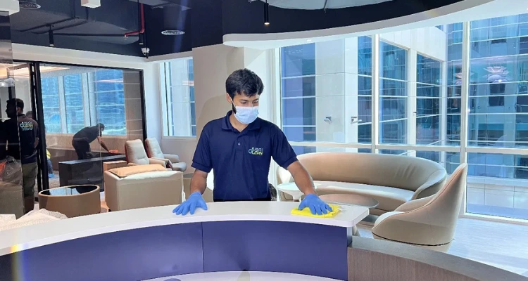 Office deep cleaning process – professionals sanitizing workplace surfaces and equipment