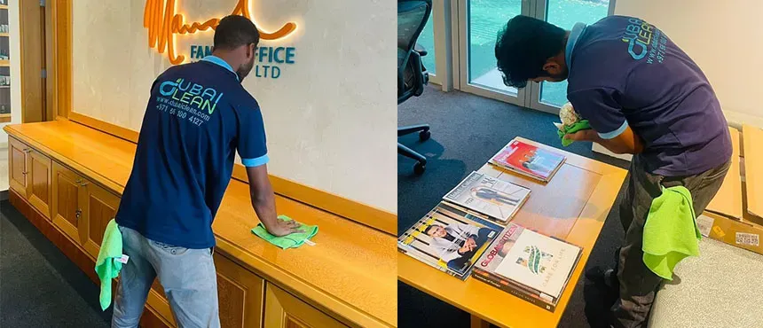 Professional cleaner wiping office desk during regular office cleaning in Dubai